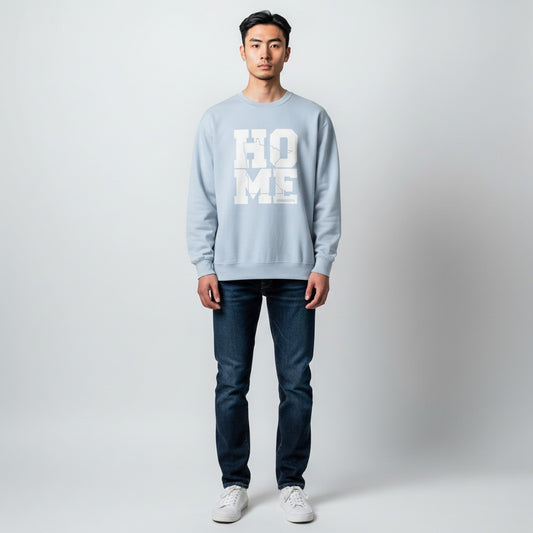Person wearing a light blue sweatshirt with 'HOME' text on a plain background