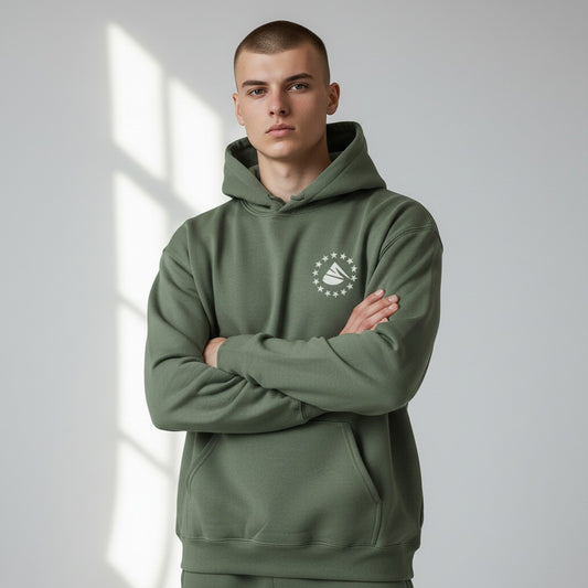 Person wearing a green hoodie with a logo on a light gray background
