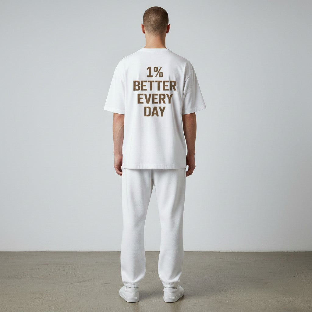 White One Percent Better Tee featuring distressed motivational typography on the back and minimalist Infinite Ascent chest logo on the front.