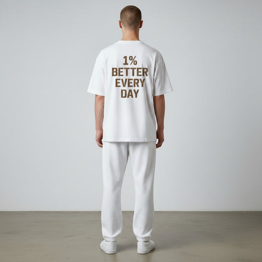 White One Percent Better Tee featuring distressed motivational typography on the back and minimalist Infinite Ascent chest logo on the front.